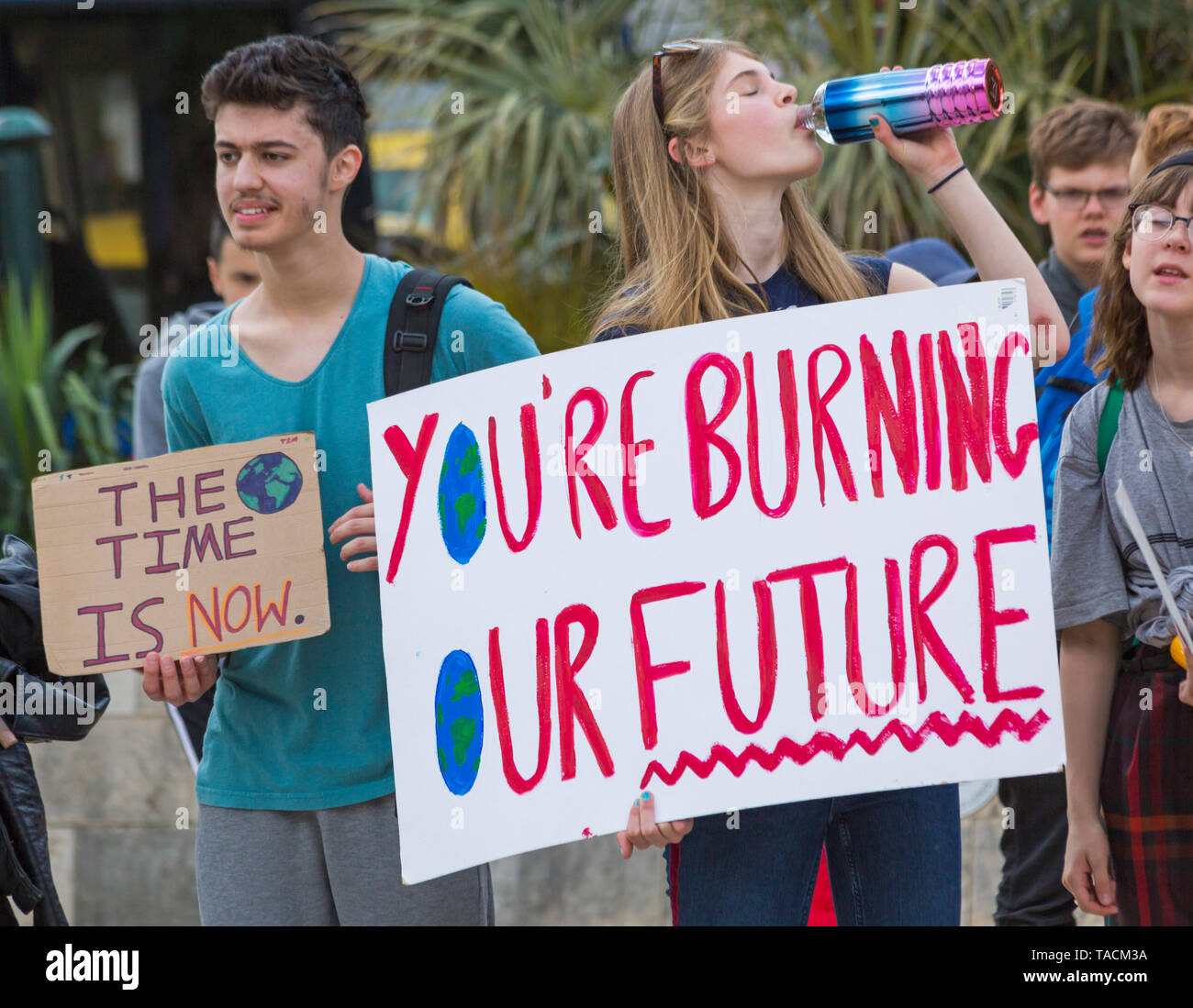 Bournemouth, Dorset, UK. 24th May 2019. Youth Strike 4 Climate gather in Bournemouth Square with their messages about climate change, before marching to the Town Hall.  You're burning our future, the time is now signs. Credit: Carolyn Jenkins/Alamy Live News Stock Photo