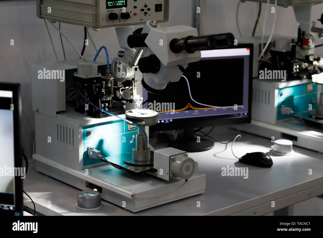 Manual ultrasonic wire bonding machines at semiconductor factory. Selective focus. Stock Photo