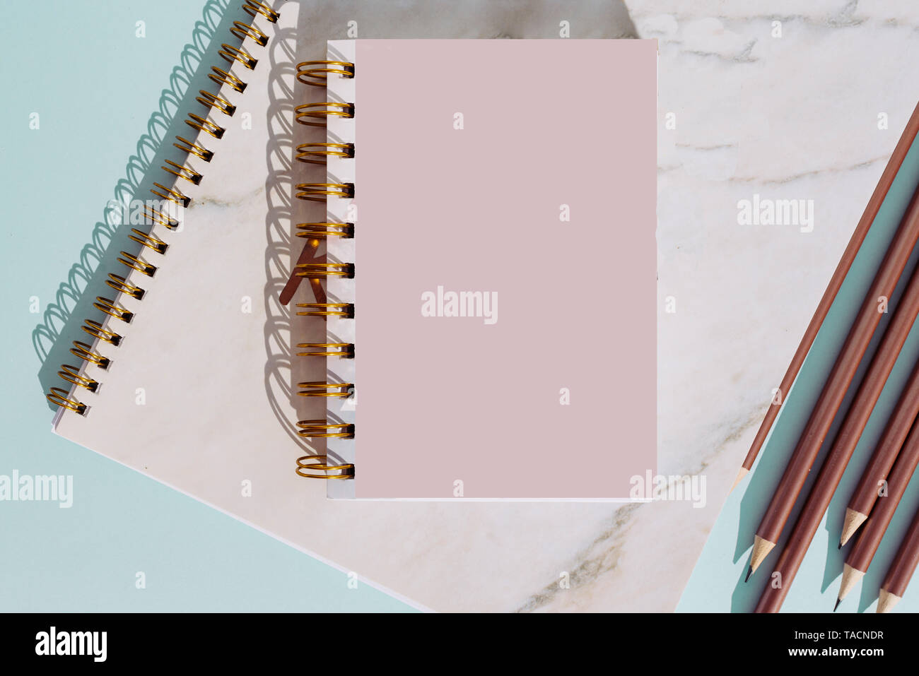 Flat lay notebook and pencil for summer holiday on turquoise background,Top view from above Stock Photo