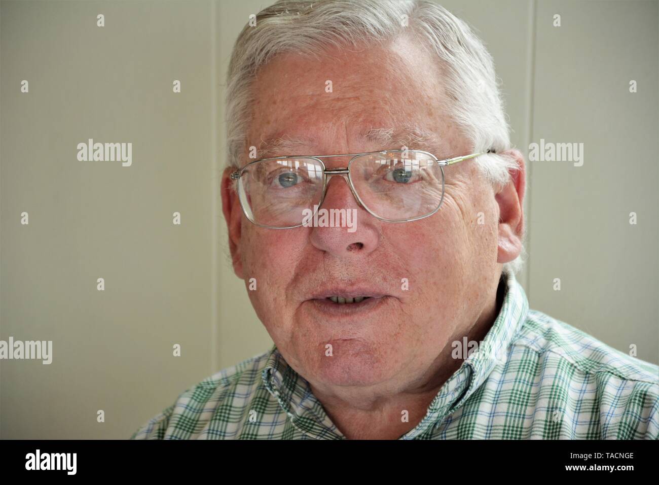 Senior man with real graying hair wearing glasses Stock Photo
