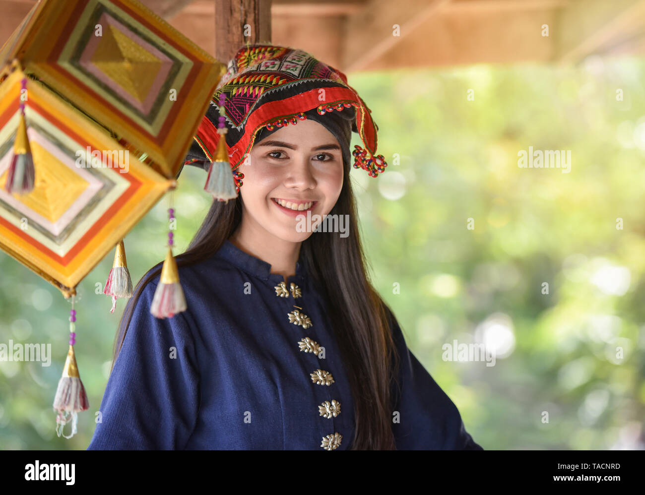 Asia woman thai style dress tribe Tai Dam / Portrait of beautiful young girl smiling Thailand traditional costume wearing with fabric woven on head Stock Photo