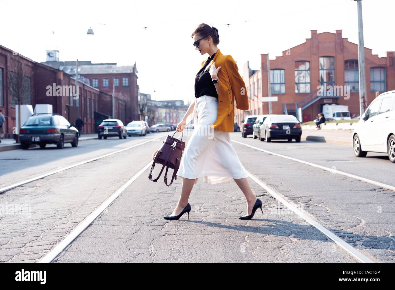 Happy young business woman walking on the street. Stock Photo