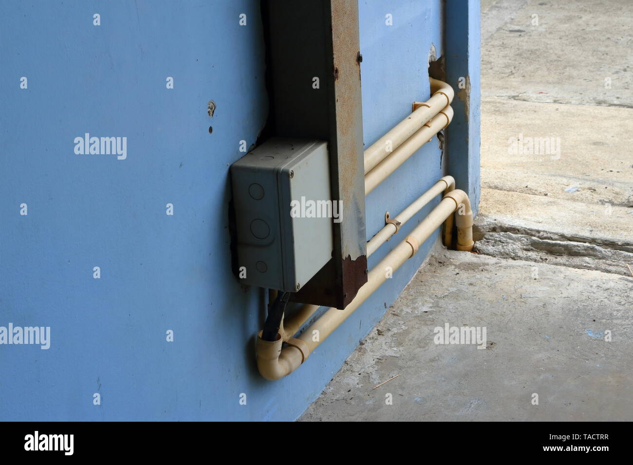 Closeup of  junction box and wireway connected to electrical pipes for power distribution, connection concept Stock Photo