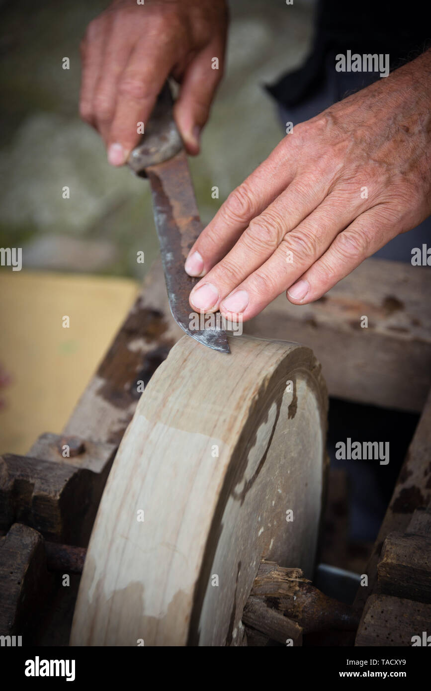 An old whetstone for sharpening knives. Grinding wheel on an old tripod.  Season of the autumn Stock Photo - Alamy