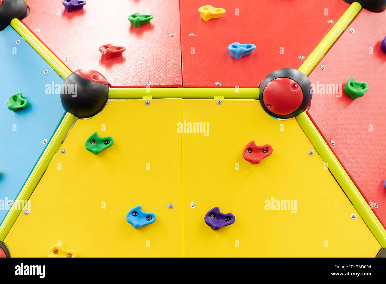 bright plastic climbing wall on the playground, closeup Stock Photo