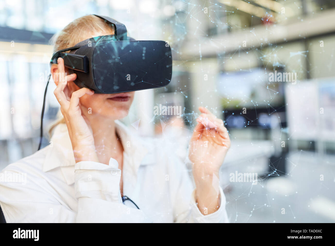 Young female doctor in clinic with visualization in front of virtual reality glasses Stock Photo