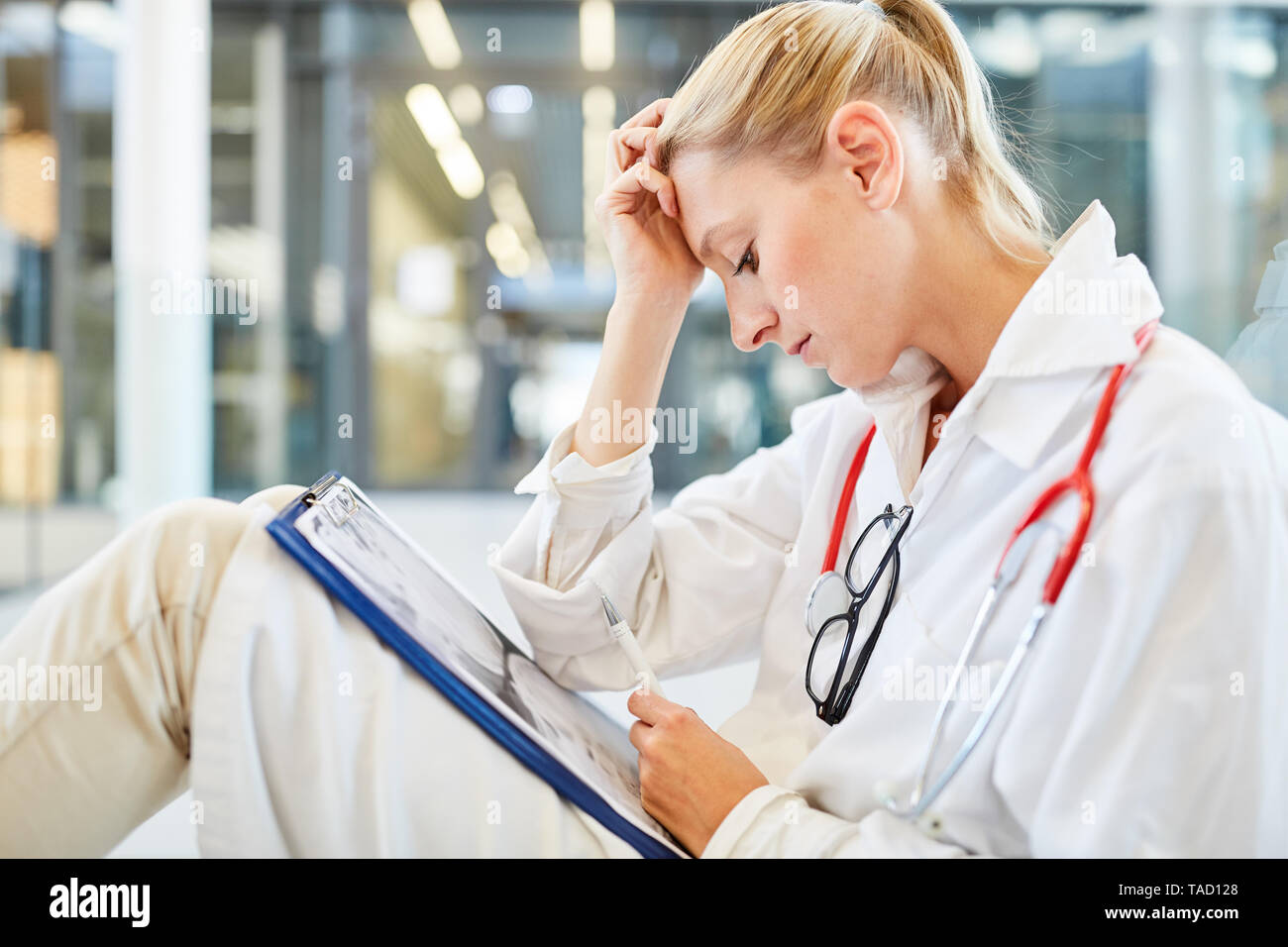 Tired female doctor sits in hi-res stock photography and images - Alamy