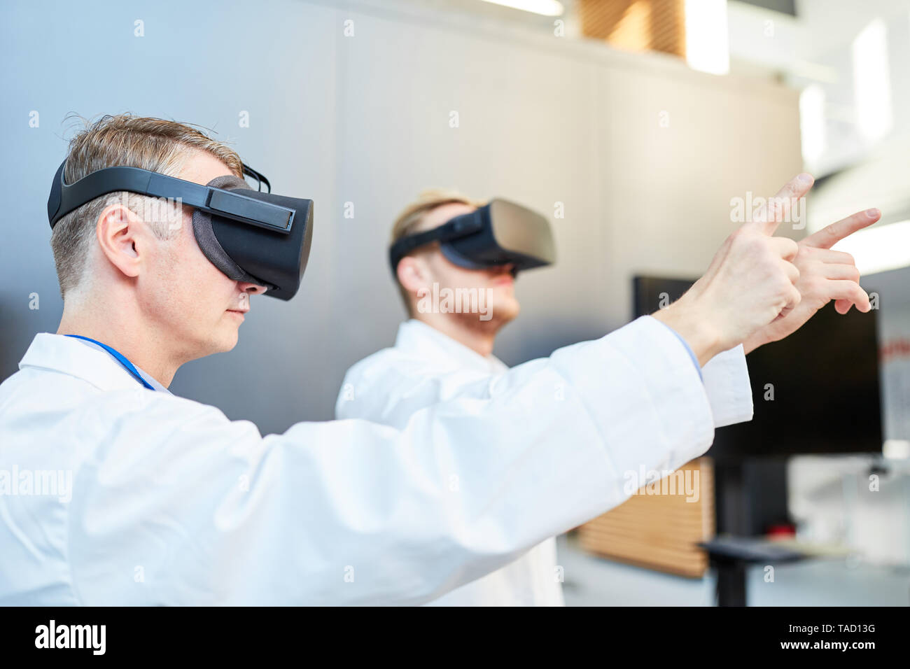 Doctors or scientists train in simulation with the Virtual Reality glasses Stock Photo