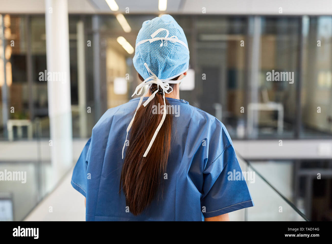 Surgeon in blue surgical gown on the way to the emergency room of the clinic Stock Photo