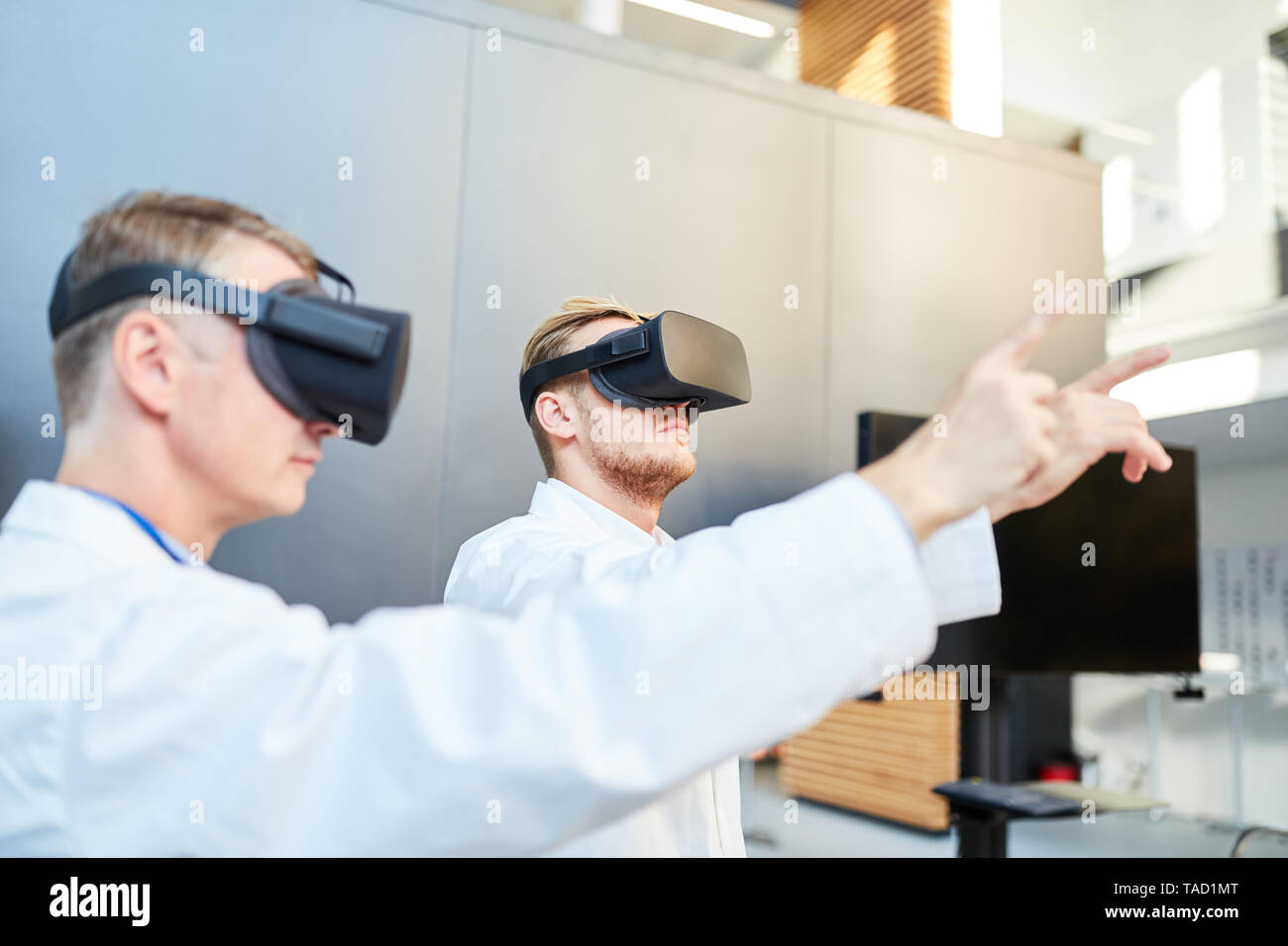Scientists train with virtual reality glasses for medicine research Stock Photo