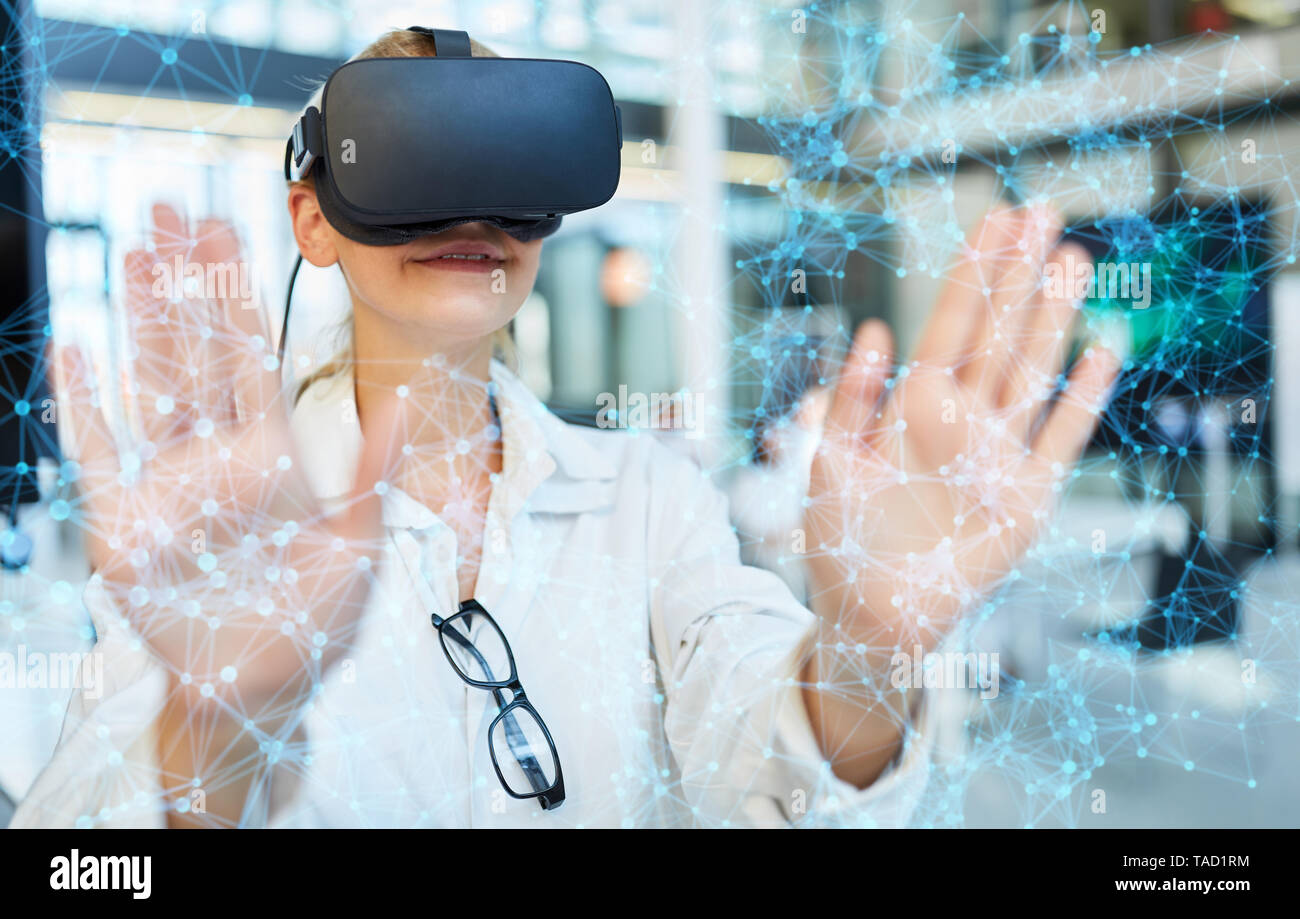Virtual reality network simulation in medicine with female doctor and VR glasses Stock Photo