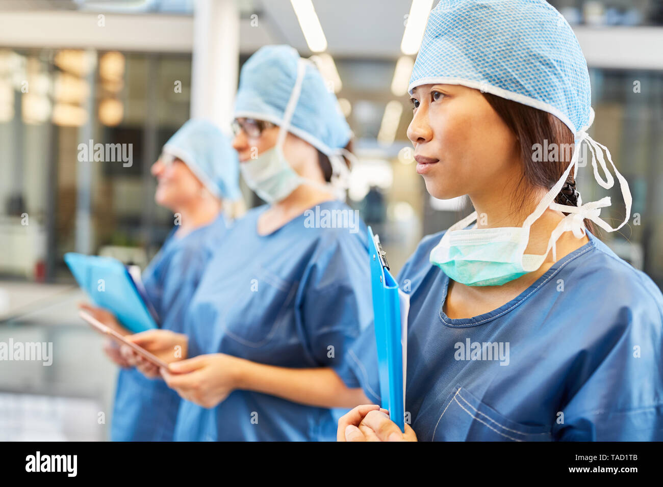 Young asian female doctor as a surgeon in emergency clinic multicultural medical team Stock Photo