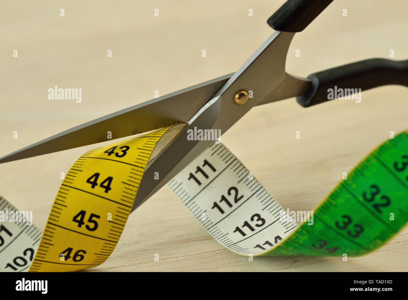 Scissors cutting measuring tape - Concept of dieting and slimming Stock Photo