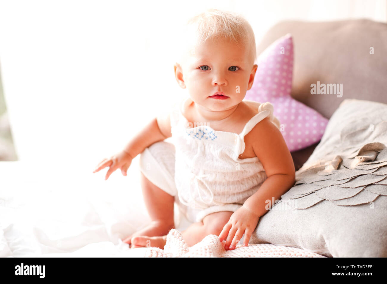 Cute baby girl sitting in bed. Good morning. Childhood Stock Photo ...