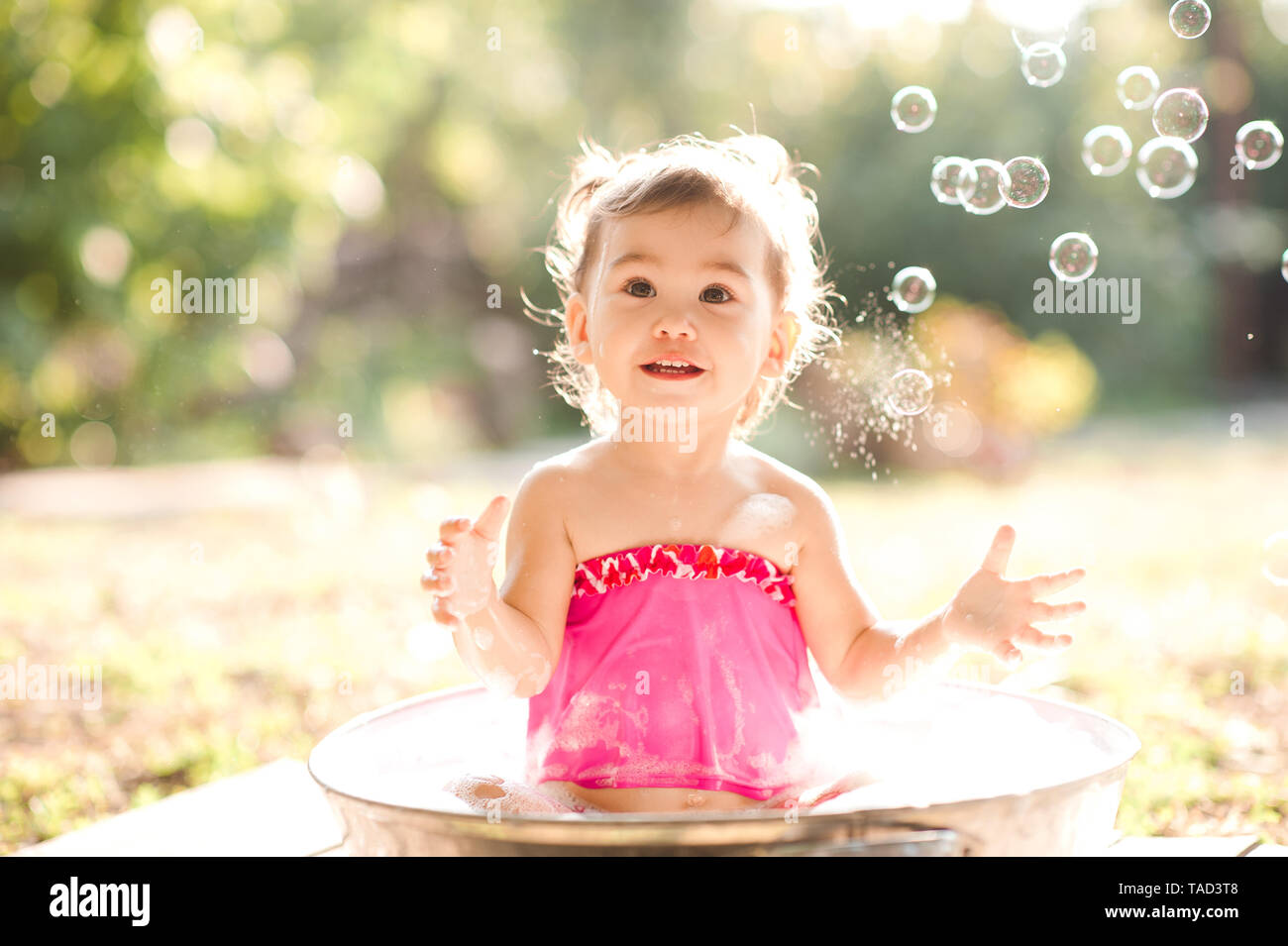 Baby girl taking bath hires stock photography and images Alamy