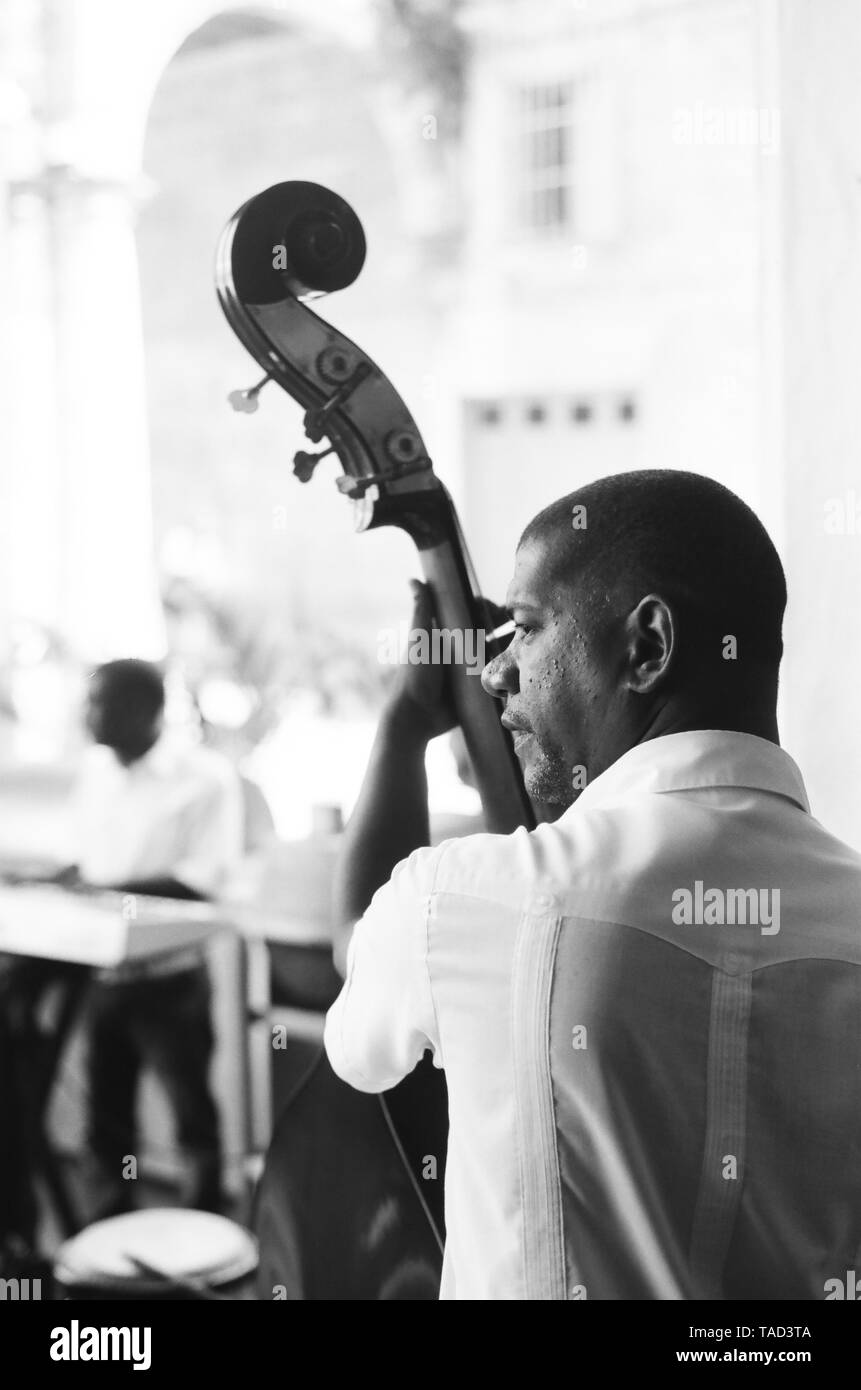 A bass player entertains the crowd in Havana Cuba Stock Photo