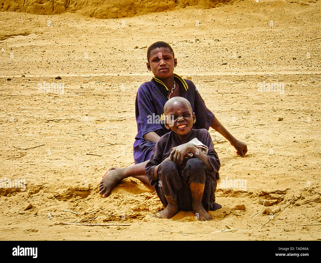 Poor Rural Mali TIMBUKTU, MALI - February circa, 2019. Unidentified two child teen boys ...