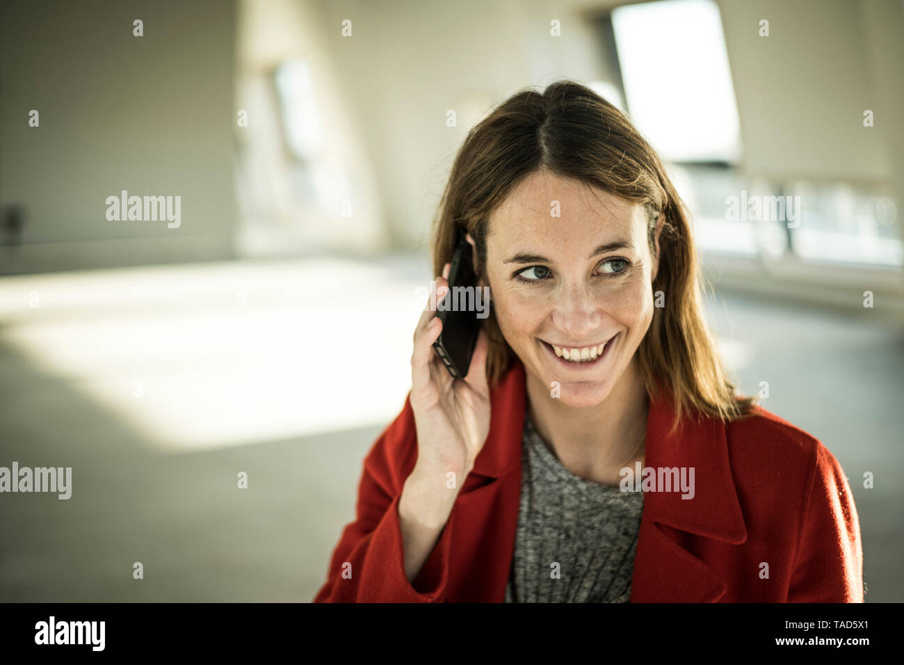 Businesswoman talking on the phone in new office rooms Stock Photo