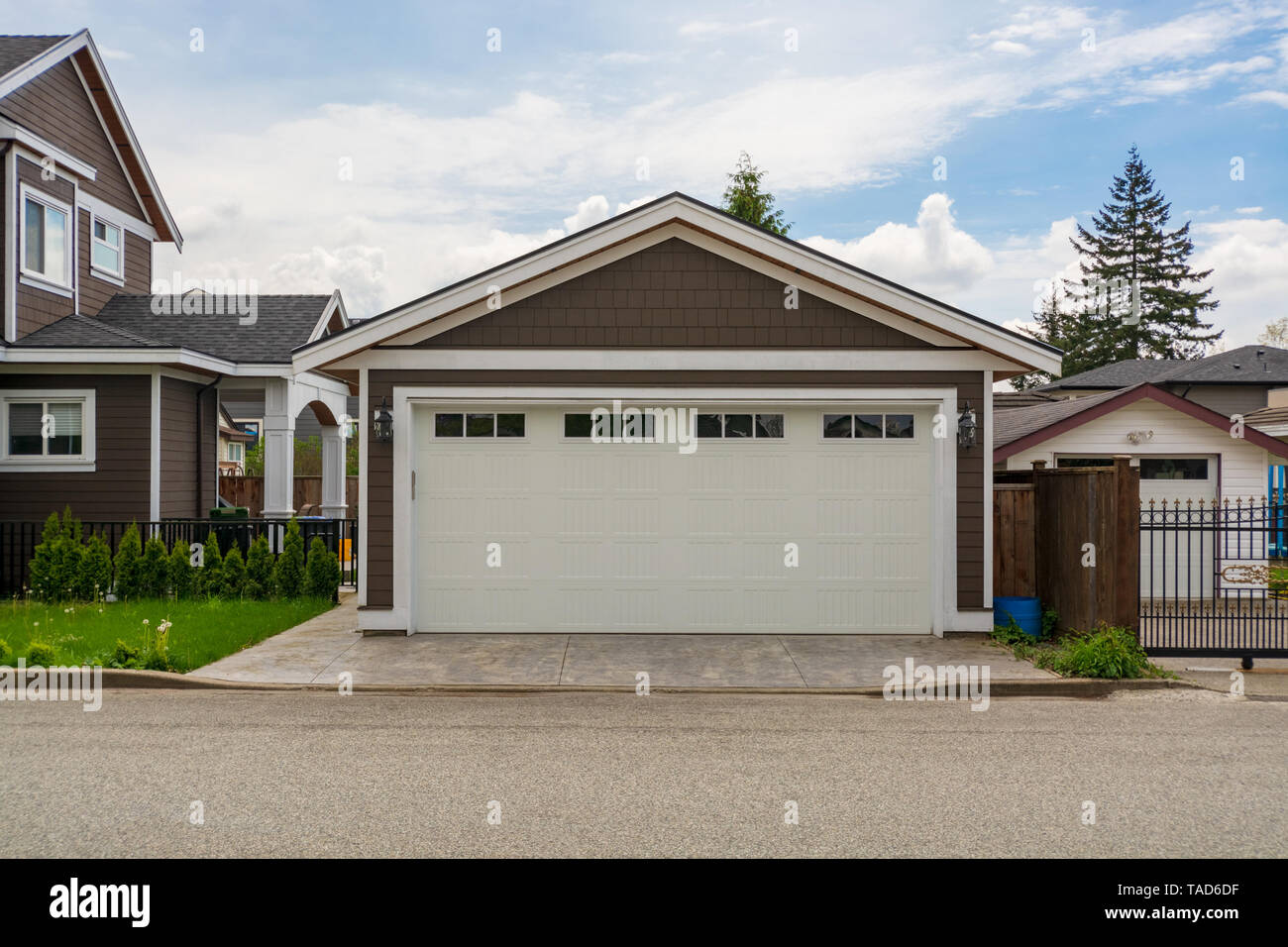 Detached Garage Of Residential House With Asphalt Road In Front