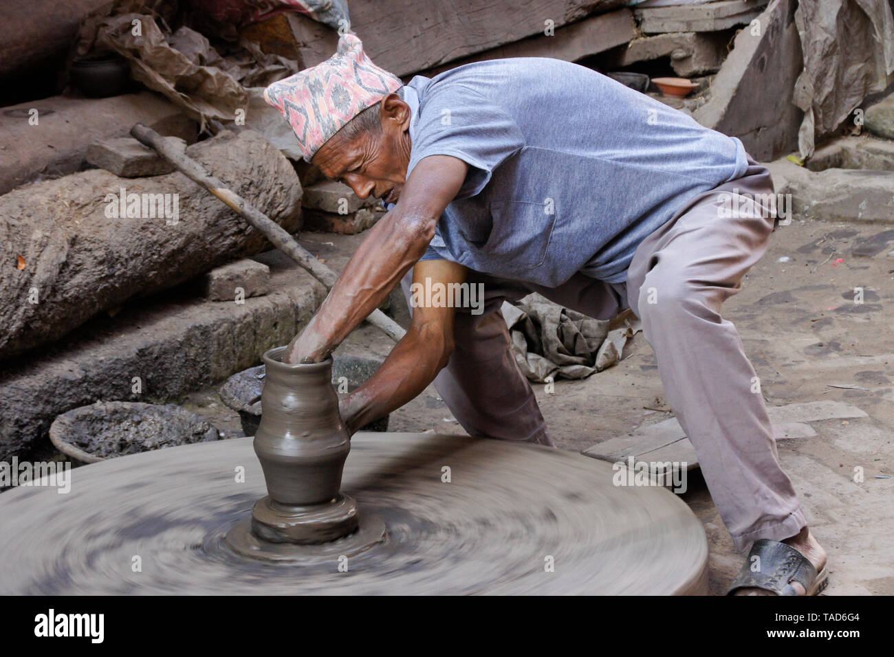 Potter turning clay pot on wheel near Kumale Tol (Potters' Square, Pottery Square), Bhaktapur, Kathmandu Valley, Nepal Stock Photo