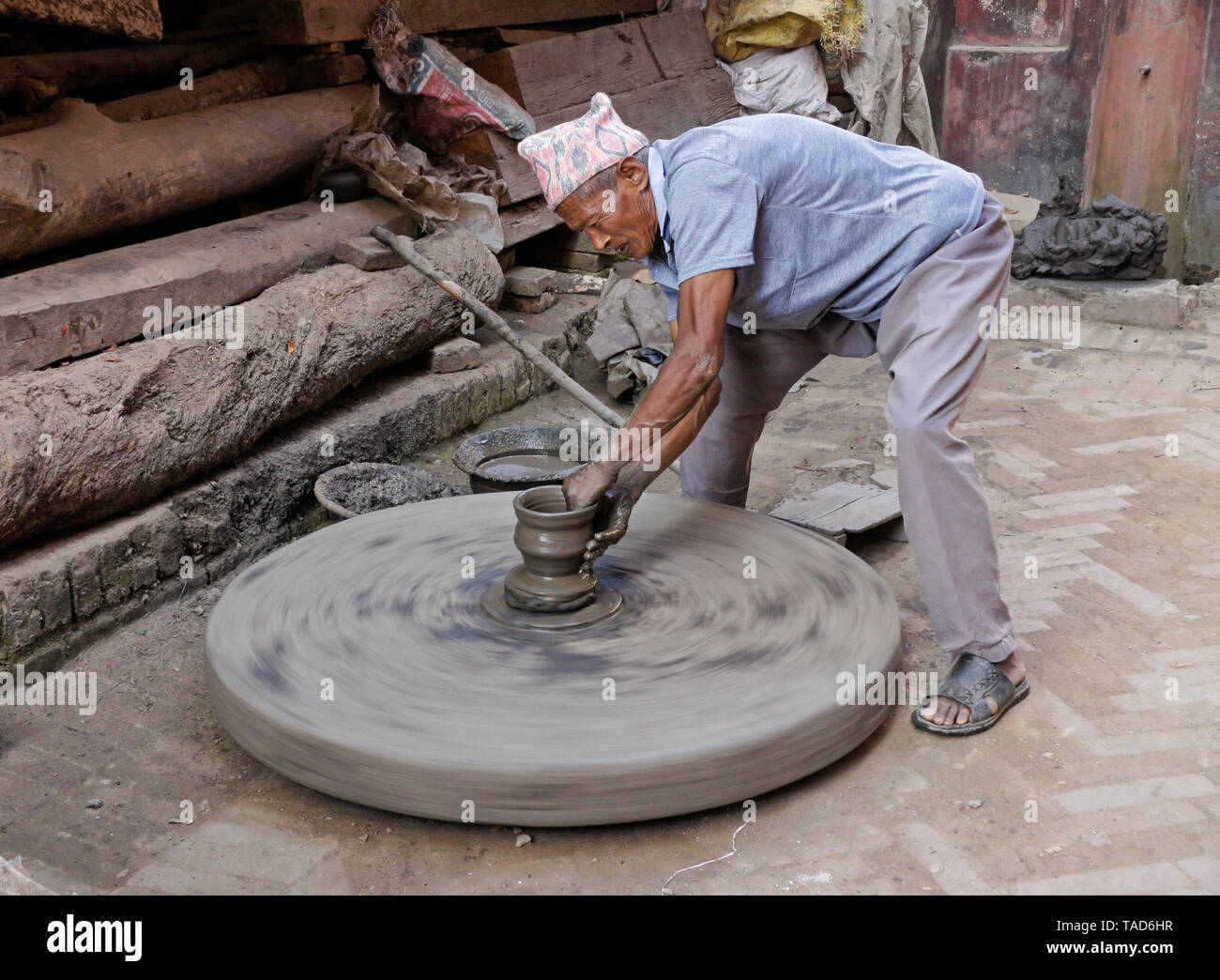 Potter turning clay pot on wheel near Kumale Tol (Potters' Square, Pottery Square), Bhaktapur, Kathmandu Valley, Nepal Stock Photo