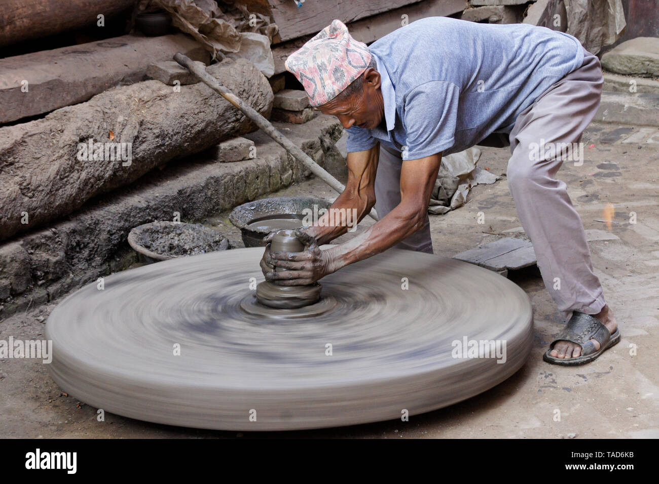 Potter turning clay pot on wheel near Kumale Tol (Potters' Square, Pottery Square), Bhaktapur, Kathmandu Valley, Nepal Stock Photo