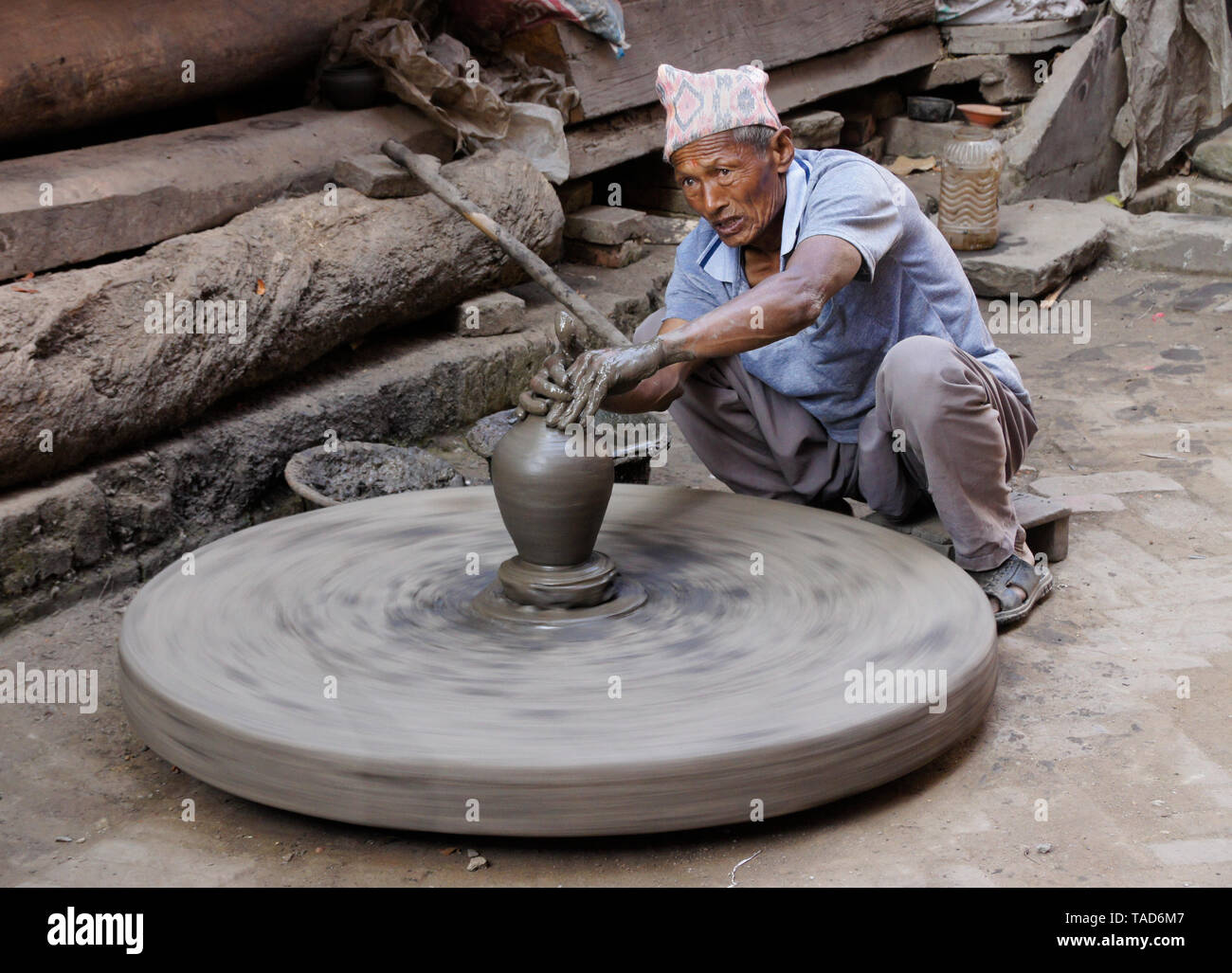 Potter turning clay pot on wheel near Kumale Tol (Potters' Square, Pottery Square), Bhaktapur, Kathmandu Valley, Nepal Stock Photo