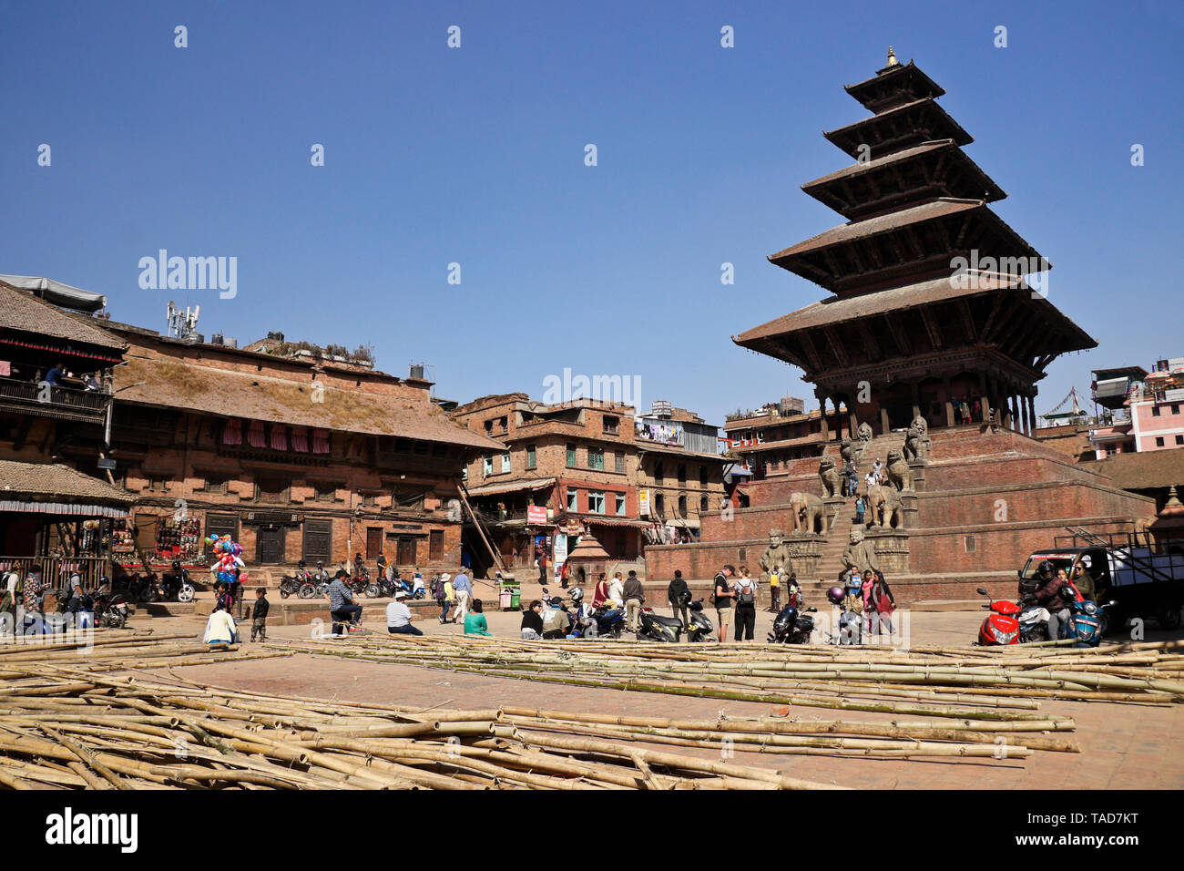 Bamboo scaffolding is piled in Taumadhi Tol, flanked by Newari buildings and the five-tiered Nyatapola pagoda temple, Bhaktapur, Kathmandu Valley, Nep Stock Photo