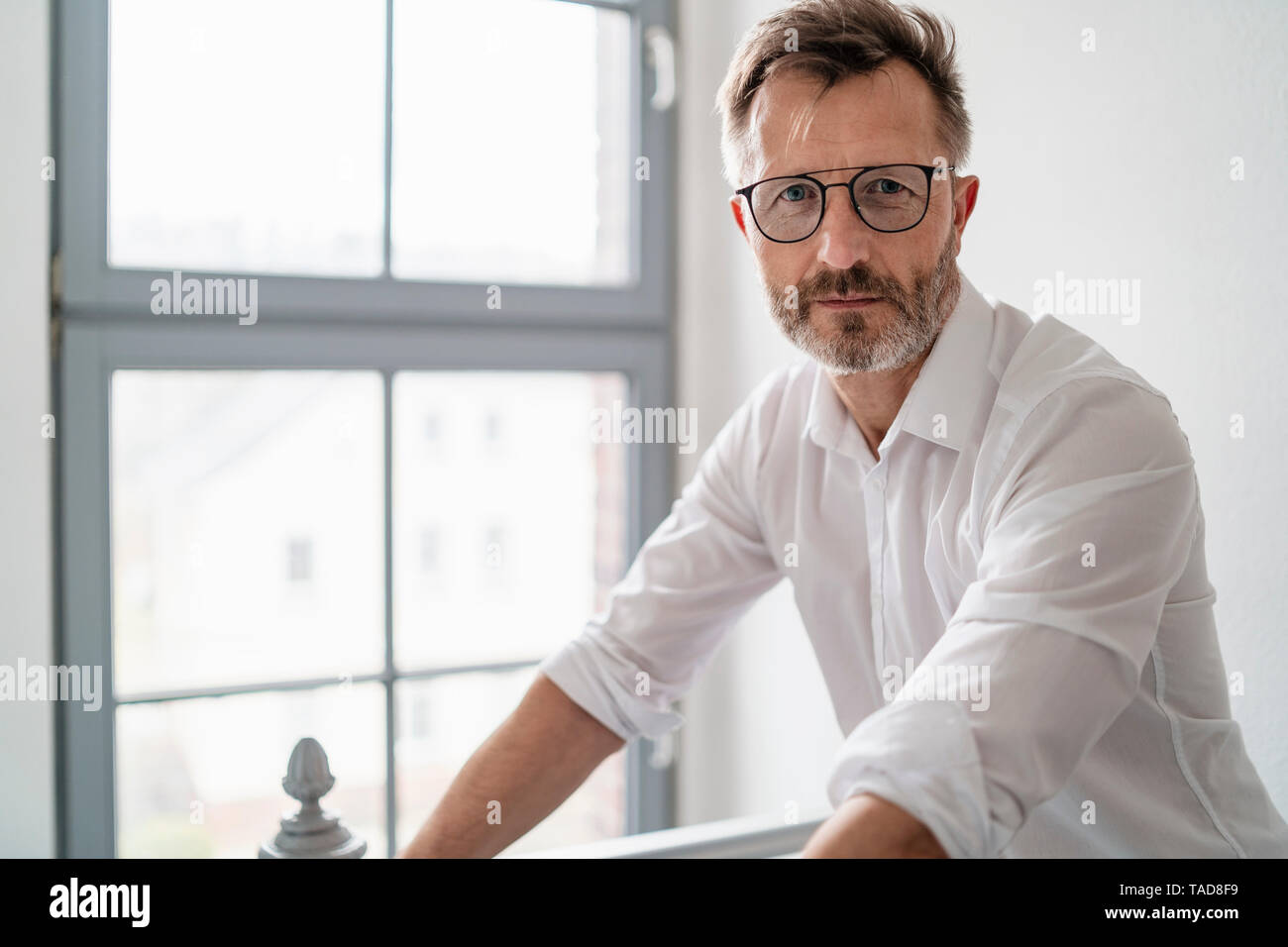 Portrait of confident businessman at the window in office Stock Photo