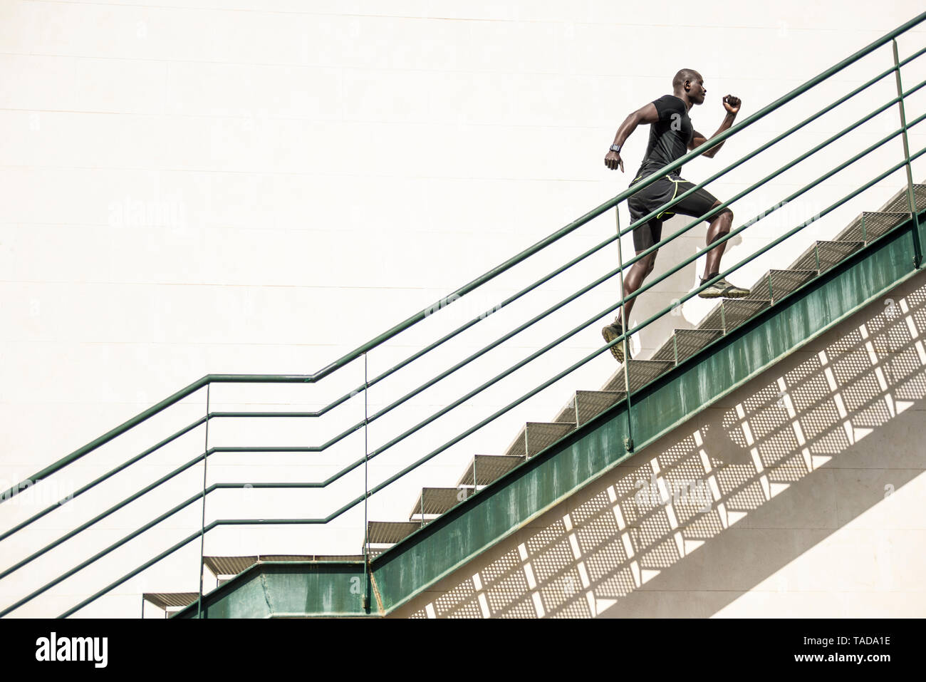 Black man running up stairs hi-res stock photography and images - Alamy