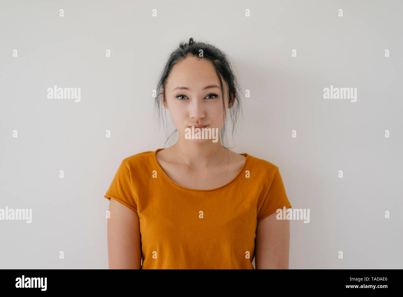Portrait of a young woman wearing yellow t-shirt Stock Photo