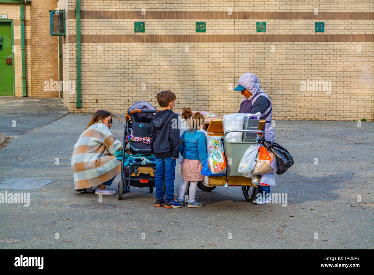 Kids are waiting for the ice cream by the ice cream cart. Stock Photo