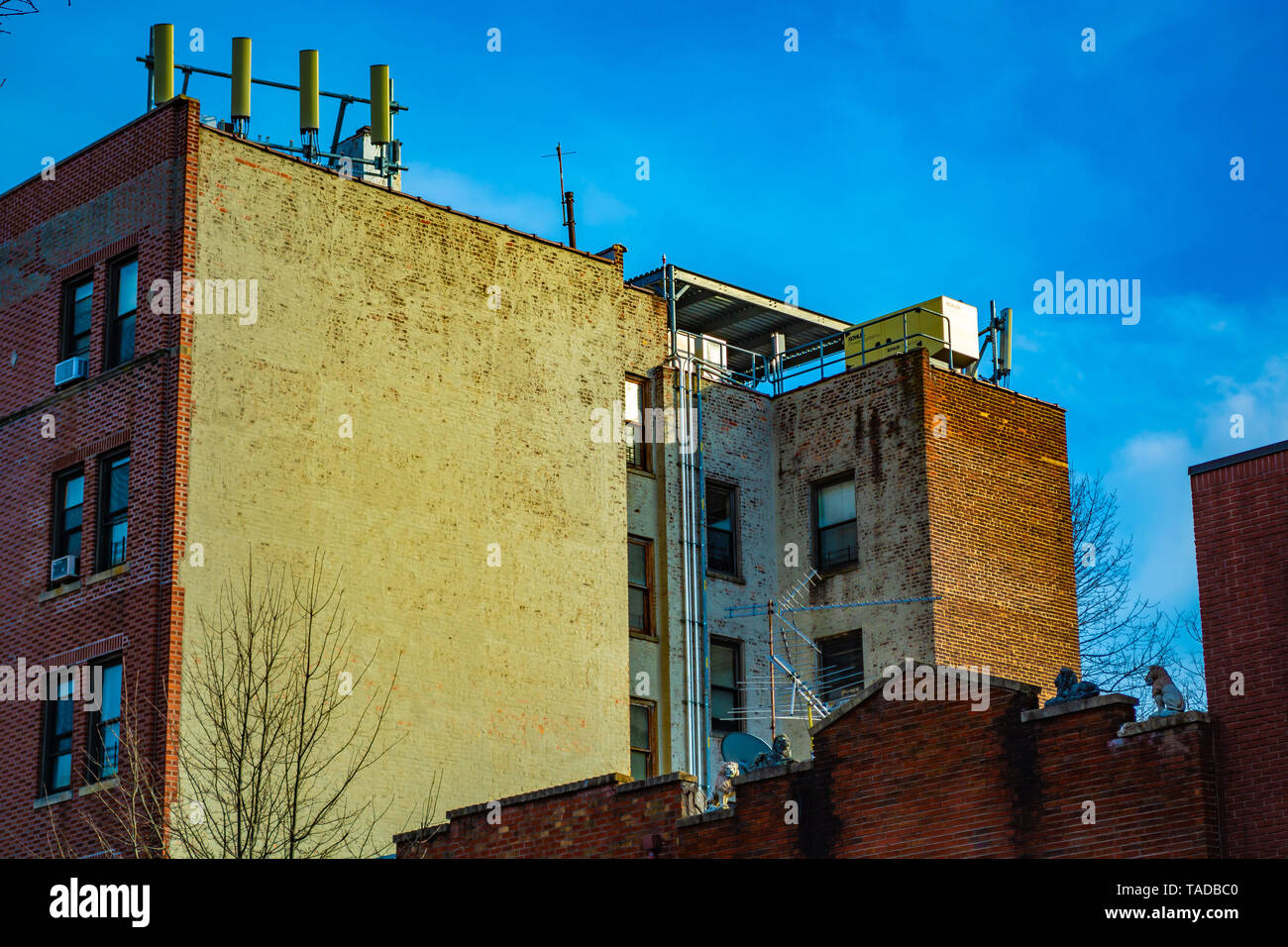Brooklyn apartment building with cellular antennas on the roof. Stock Photo