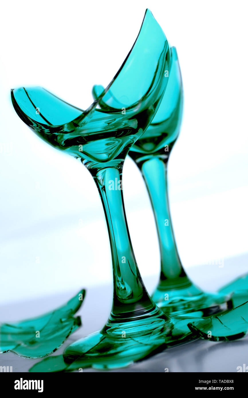 Broken Champagne Glass with shards of glass and shattered glass on white background Stock Photo