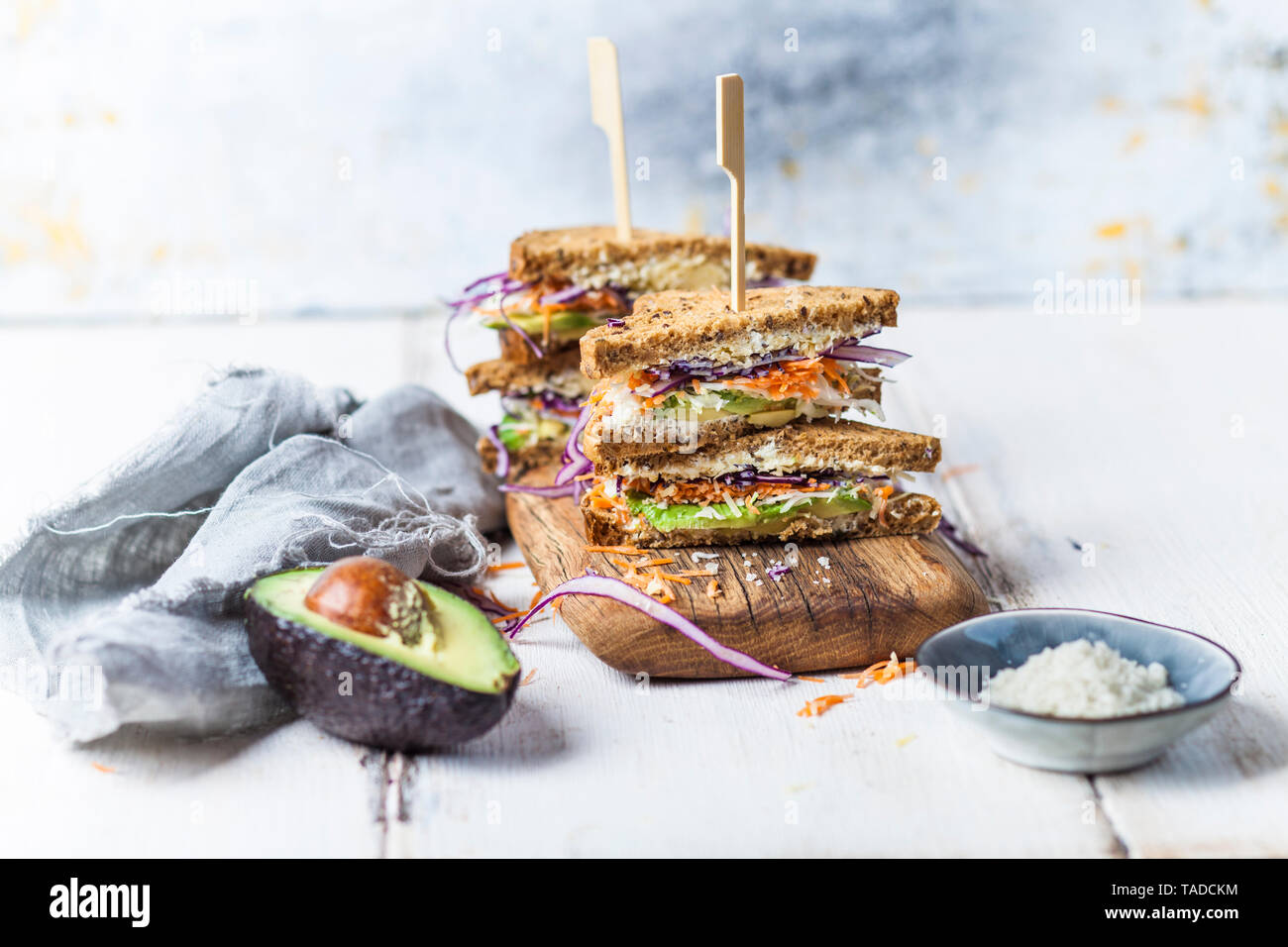 Veggie Sandwich, whole meal toast bread with grated carrot, red cabbage, white cabbage, avocado and cheese Stock Photo