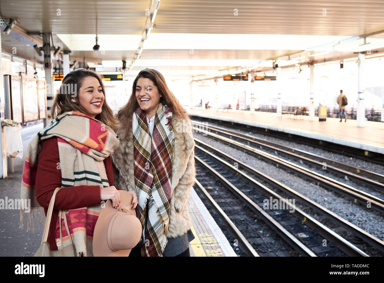 UK, London, two happy women at underground station platform Stock Photo