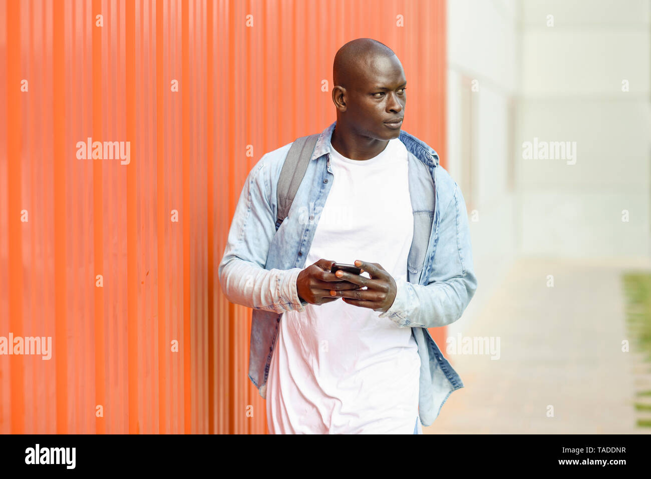 Man with smartphone wearing casual denim shirt Stock Photo
