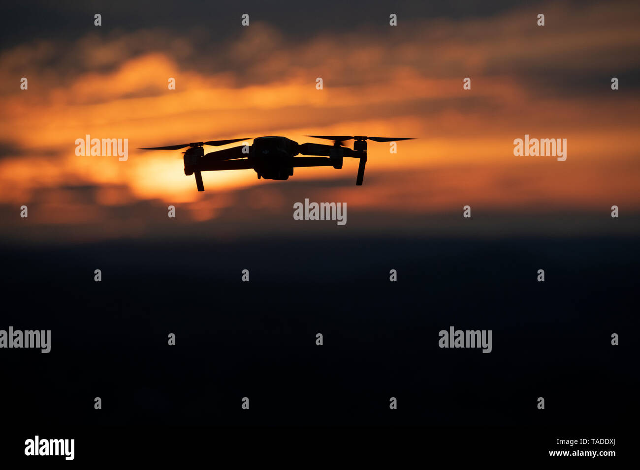A drone flying above the Welsh countryside at sunset. Stock Photo