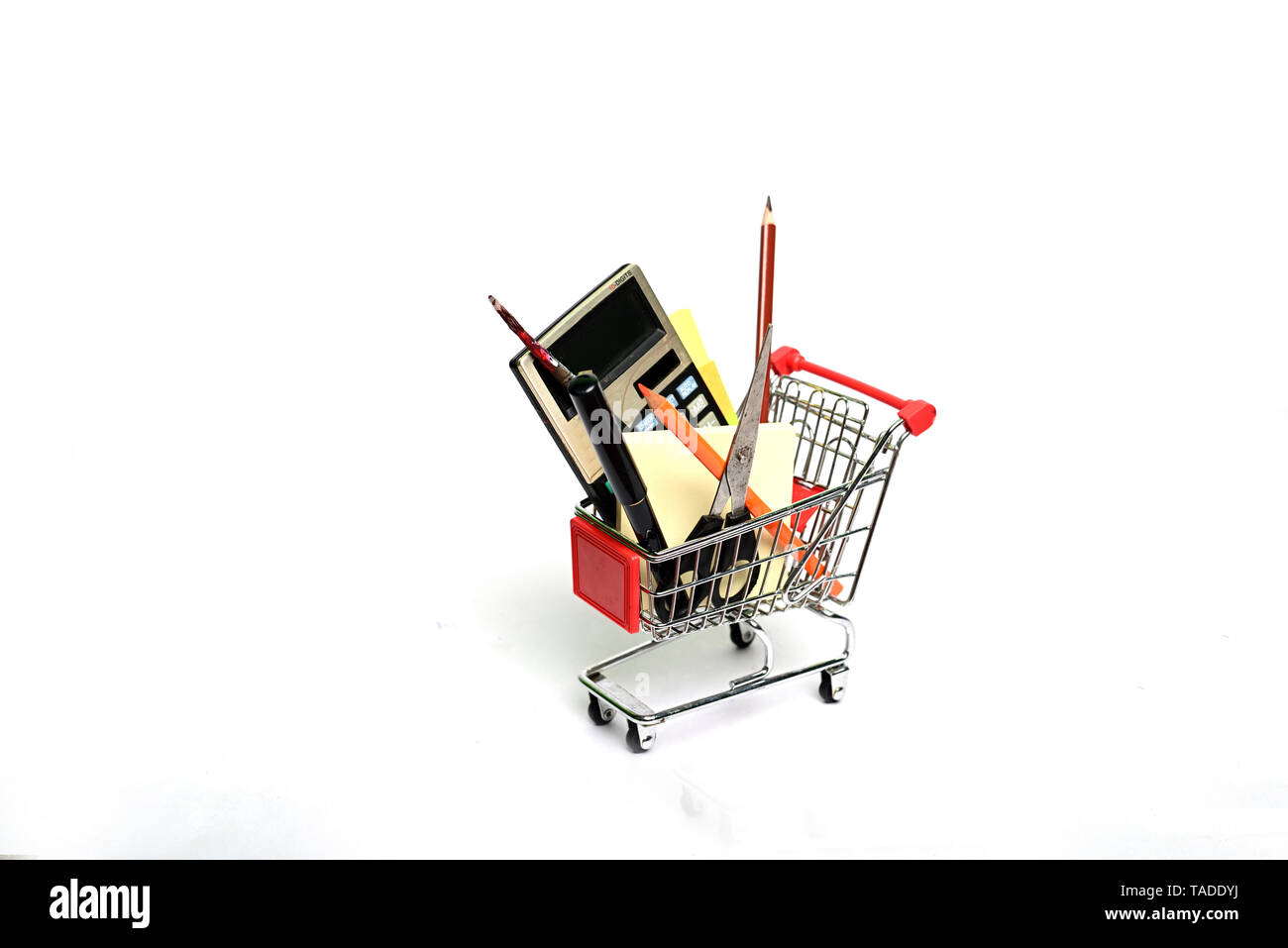 Shopping cart full with education goods for study om white background