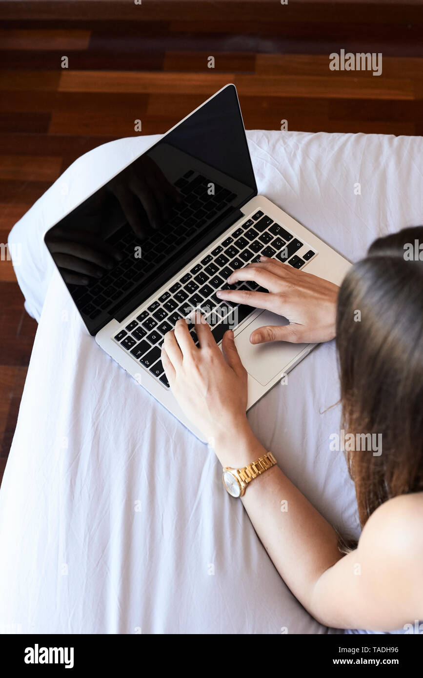 Woman lying on bed with laptop hi-res stock photography and images - Alamy