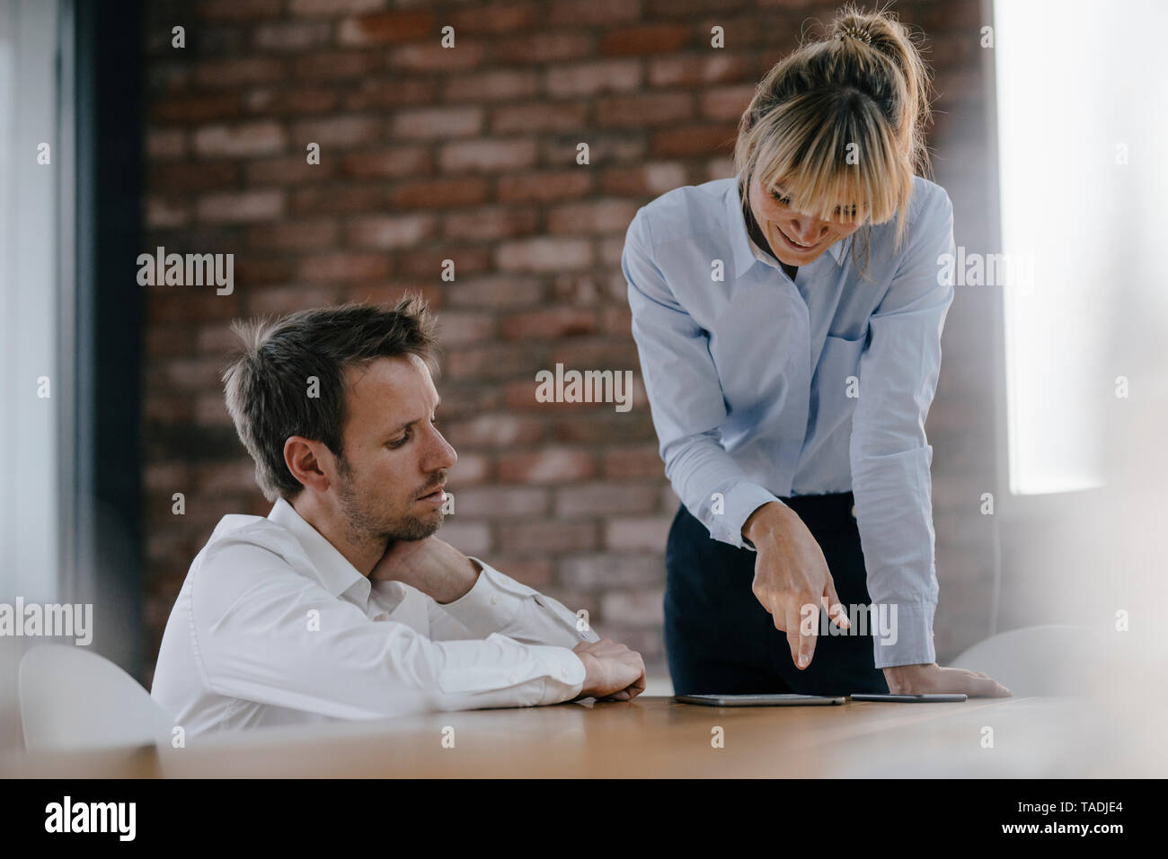 Business people working together on a project, using laptop Stock Photo