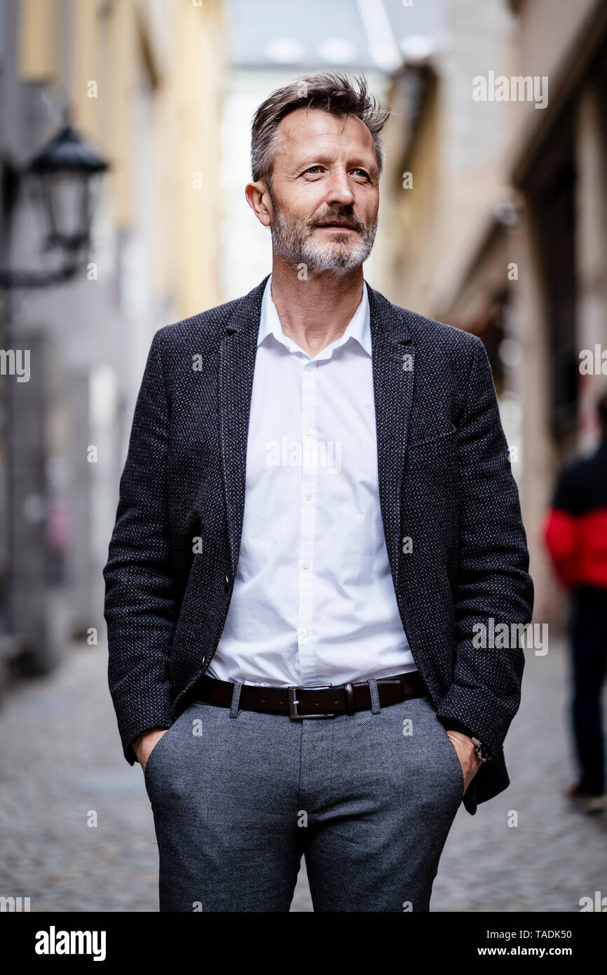 Portrait of mature businessman with greying beard in the city Stock Photo