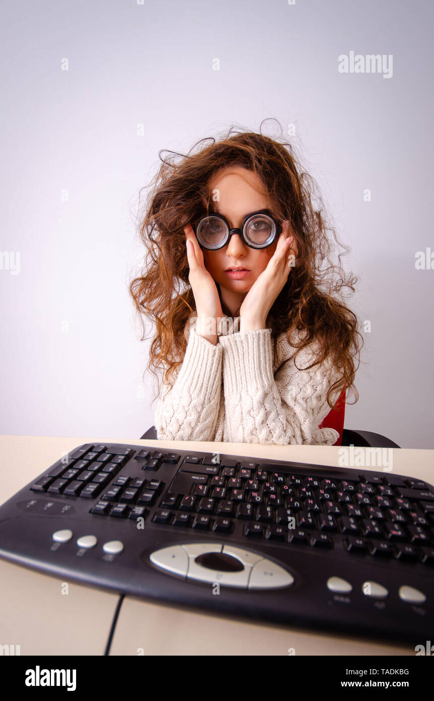 Funny nerd girl working on computer Stock Photo