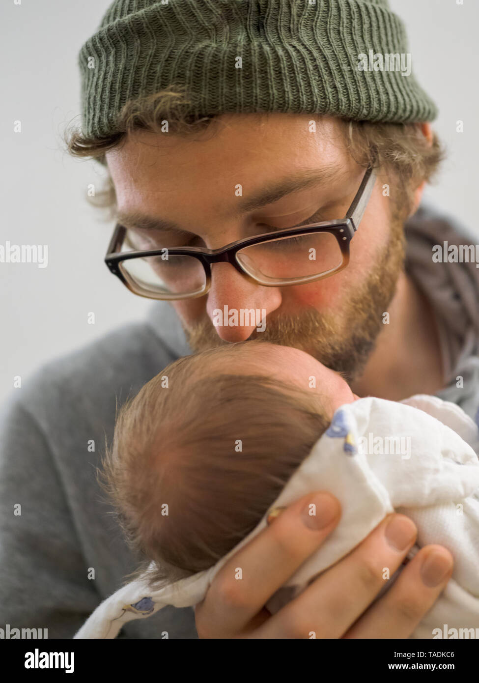 Father kissing his newborn girl Stock Photo