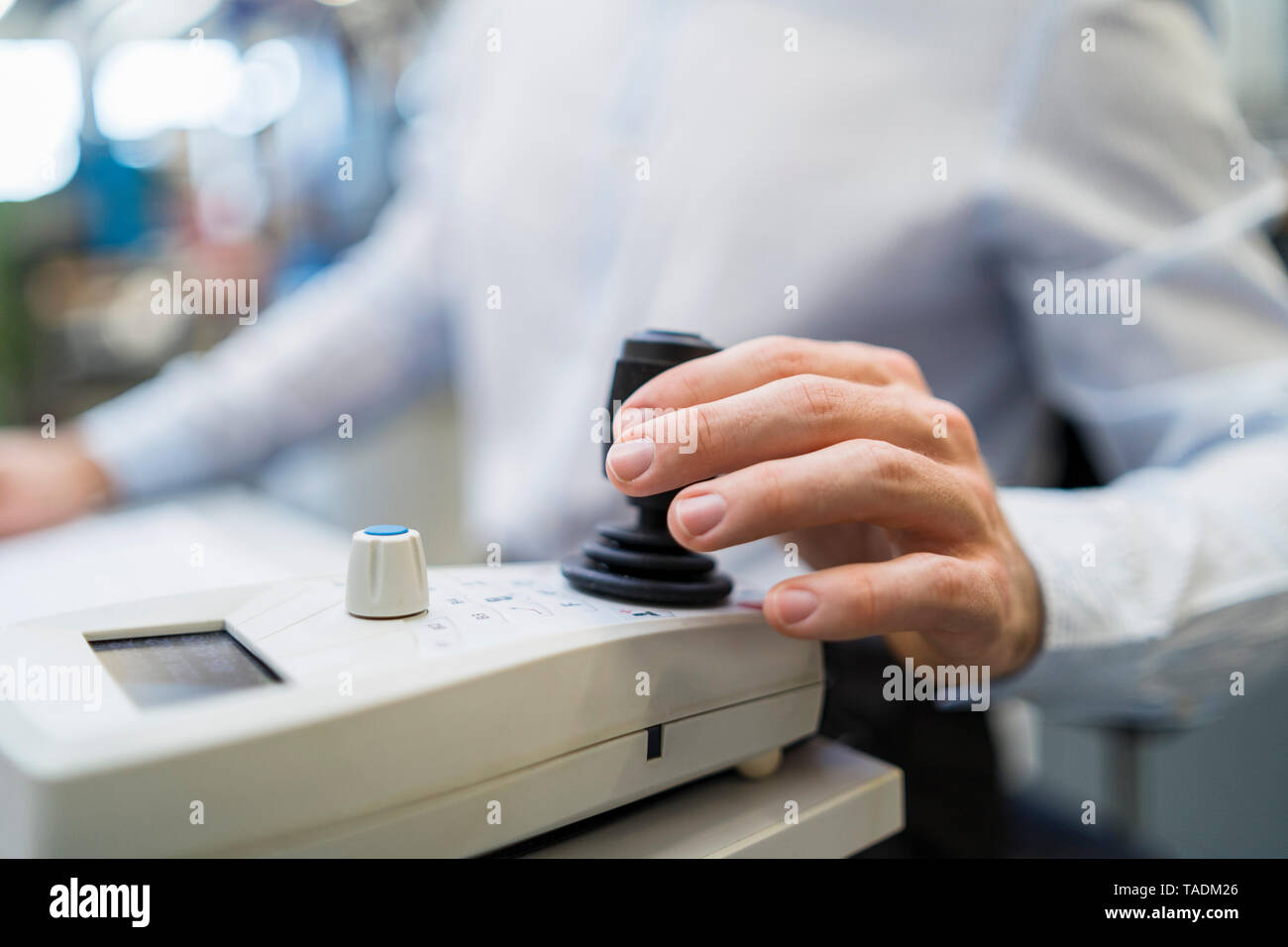 Close-up of man operating machine with control in a factory Stock Photo
