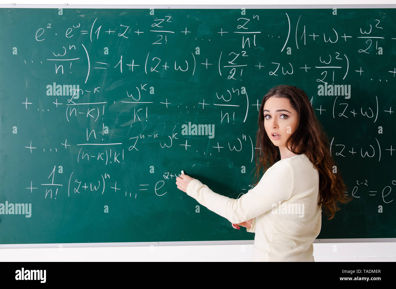 Young female math teacher in front of chalkboard Stock Photo - Alamy