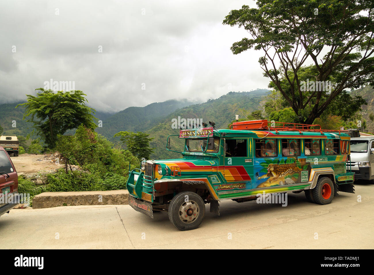 On a mountain road on a colorful jeepney Stock Photo