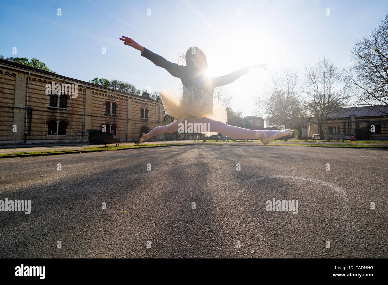 Italy, Verona, Ballerina dancing in the city jumping midair Stock Photo