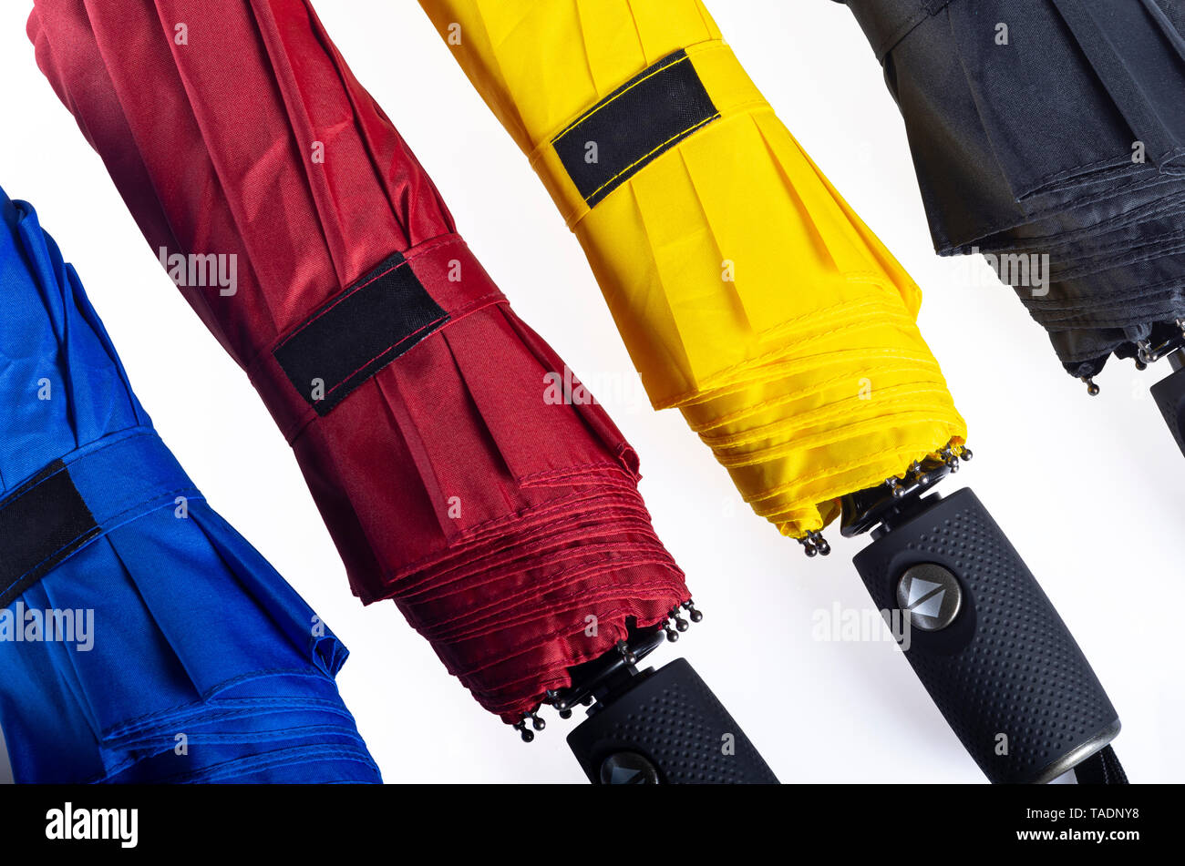 Multicolored folded umbrellas isolated on white Stock Photo