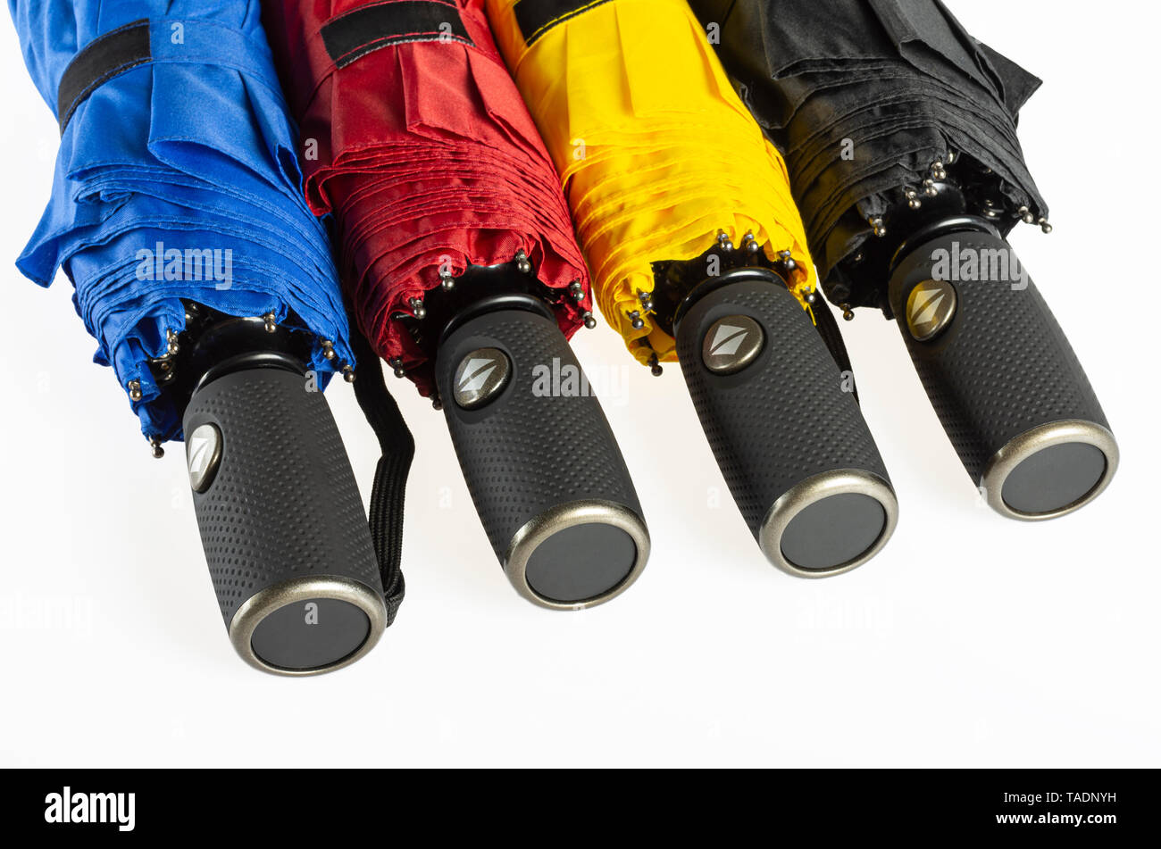 Multicolored folded umbrellas isolated on white Stock Photo